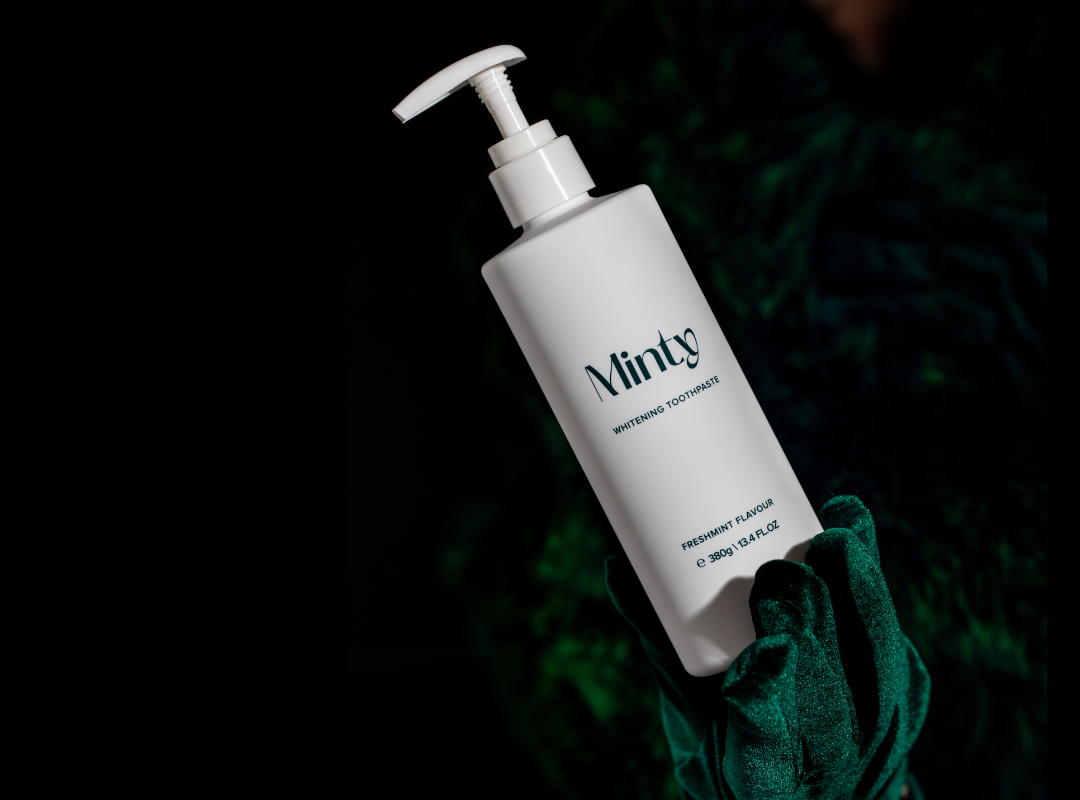 Minty 380g pump toothpaste bottle being held in luxury